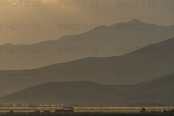 Mountain landscape in fog at sunset