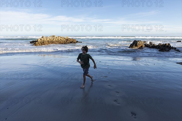Boy running on Voelklip Beach