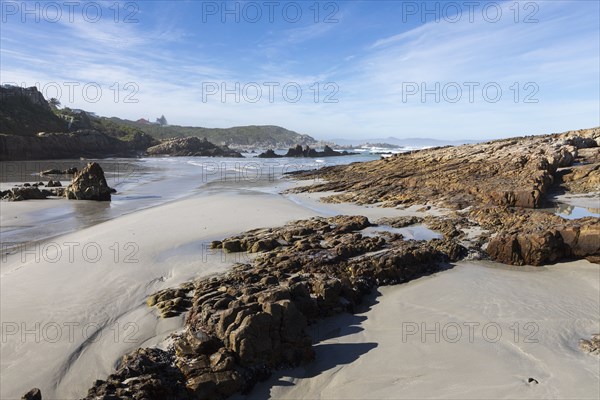 Rocky coastline in Kammabaai Beach on sunny day