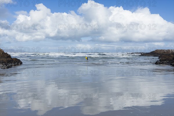 Distant view of boy bodyboarding