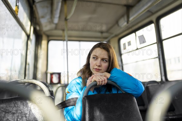 Portrait of woman looking through window while sitting in tram