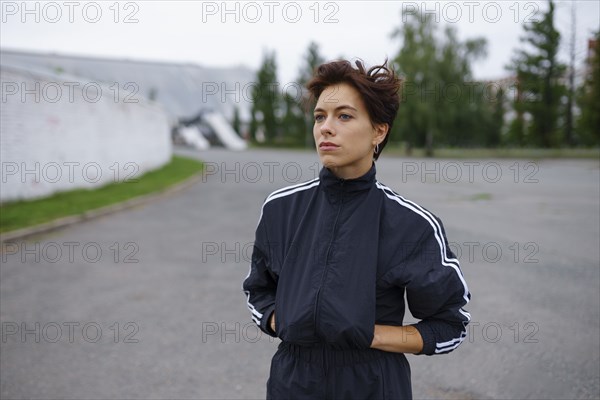 Serious brunette wearing tracksuit