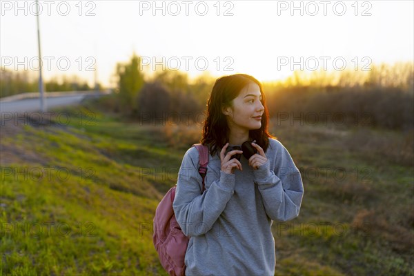 Woman with headphones and backpack