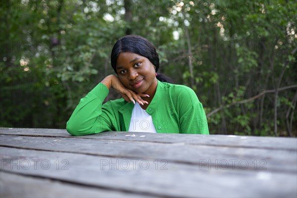 Smiling woman sitting at picnic table