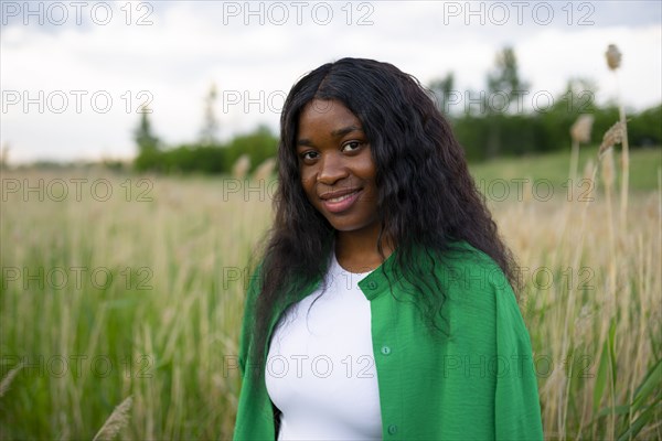 Portrait of smiling brunette in field