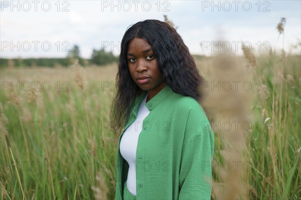 Portrait of brunette woman in field