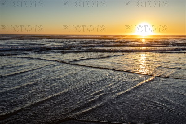 Sun setting over ocean at Cannon Beach