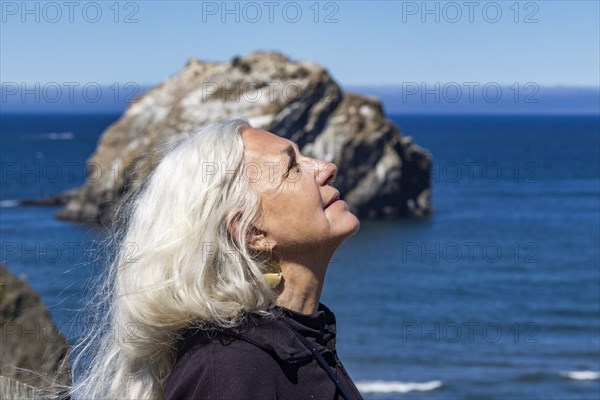 Side view of senior woman with long hair