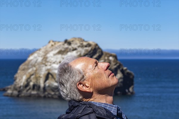 Side view of senior man looking up