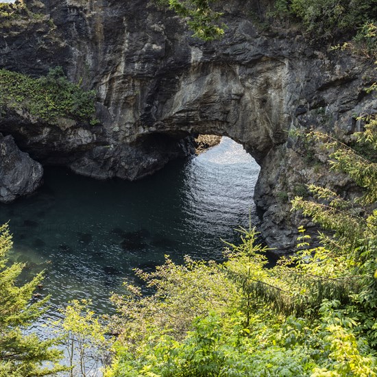 Natural arch formation above rippled sea