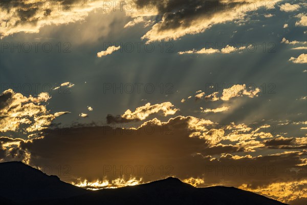 Silhouette of mountains with sunrise in background