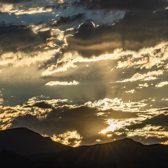 Silhouette of mountains with sunrise in background