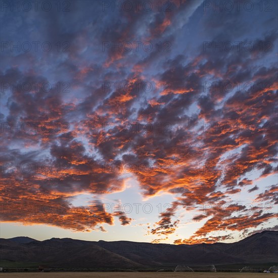 Silhouettes of mountains with sunrise in background