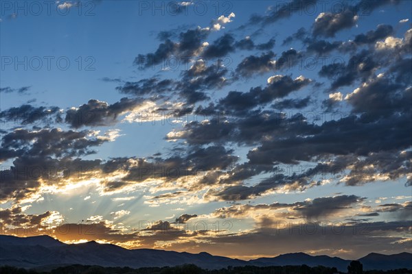 Silhouettes of mountains with sunrise in background