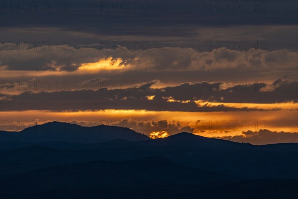 Beautiful sunset over silhouettes of mountains