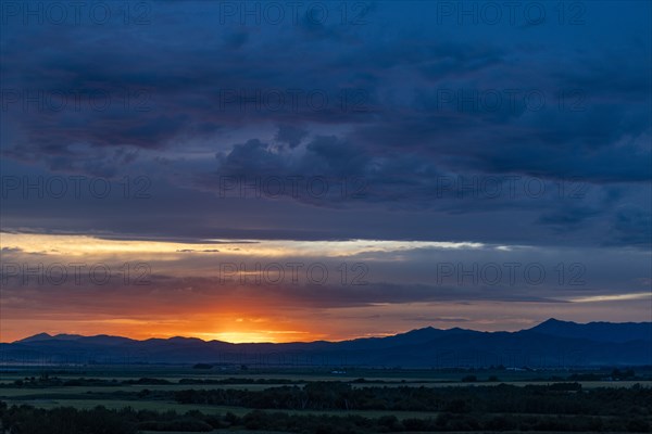 Beautiful sunset over silhouettes of mountains