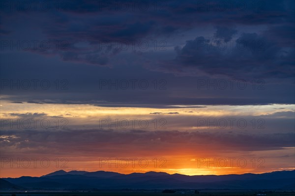 Beautiful sunset over silhouettes of mountains