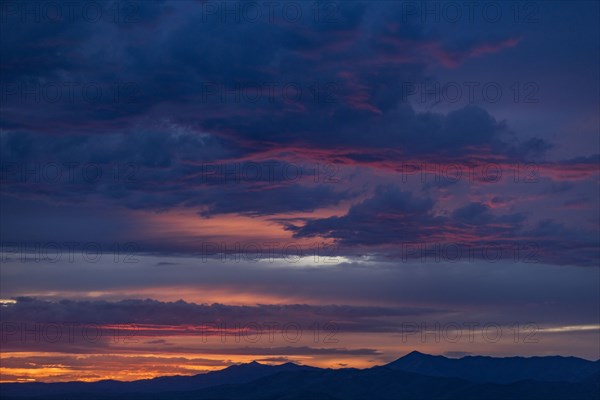 Beautiful sunset over silhouettes of mountains