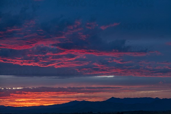 Beautiful sunset over silhouettes of mountains