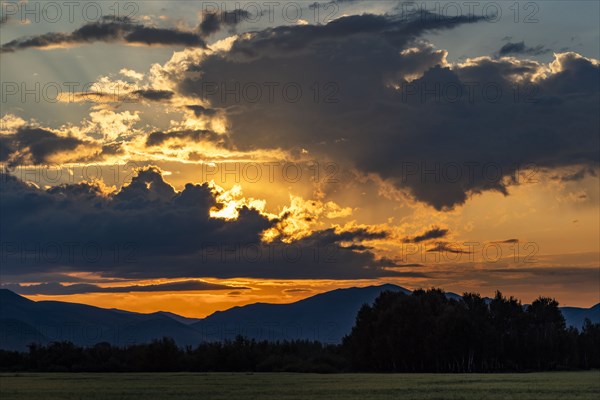 Beautiful sunrise over silhouettes of mountains