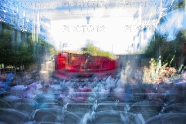 Blurred motion of stage at outdoor theater at dusk