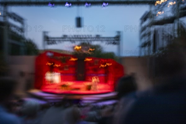 Blurred motion of stage at outdoor theater at dusk