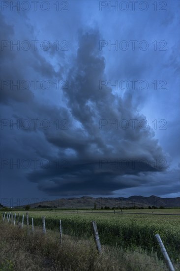 Arcus cumulonimbus storm clouds rolling across farmland