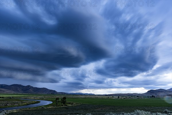 Arcus cumulonimbus storm clouds rolling across farmland