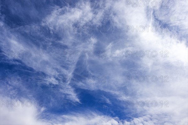 Wispy white clouds in blue sky