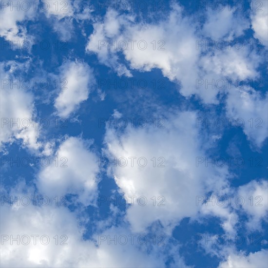 Fluffy white clouds in blue sky