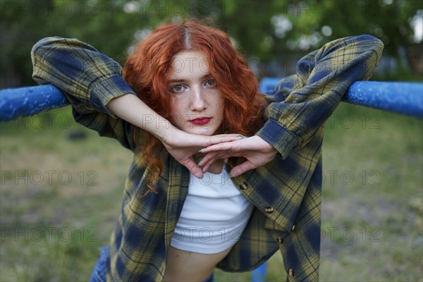 Redhaired woman posing at playground