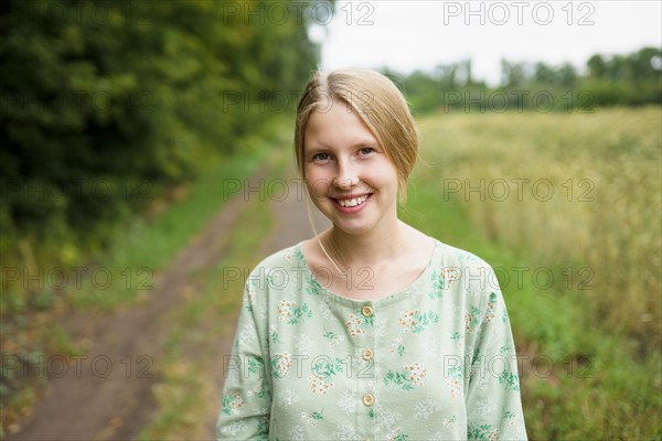 Portrait of smiling woman standing in field