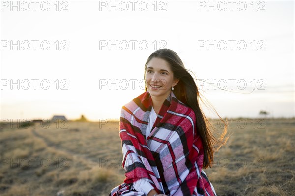 Portrait of smiling woman wrapped in scarf