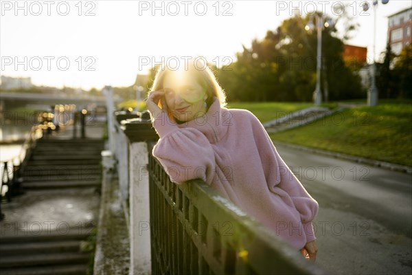 Portrait of mature woman standing by river at sunrise