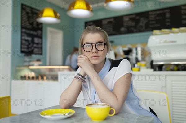 Portrait of serious woman sitting in cafe