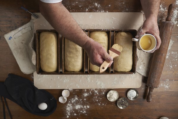 Directly above view of baker preparing bread in kitchen