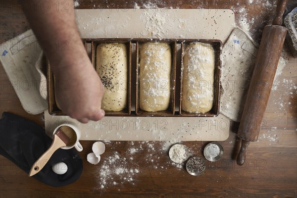 Directly above view of baker preparing bread in kitchen