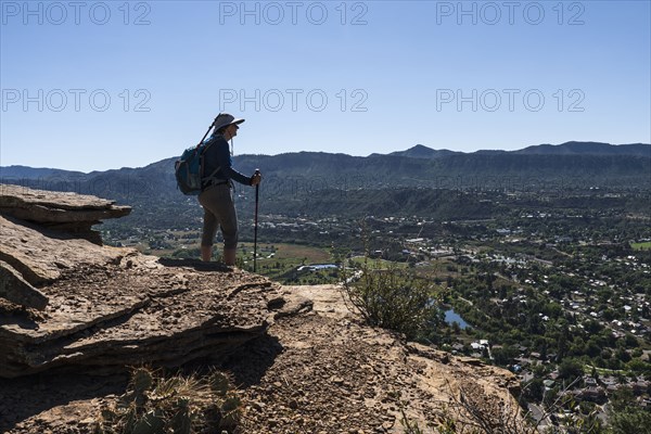 Usa, Colorado, Durango, Woman standing on ledge in San Juan Mountains