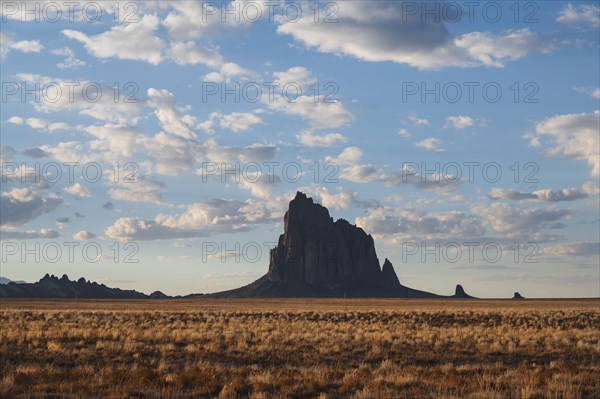 Usa, New Mexico, Shiprock, Clouds over desert landscape with Shiprock