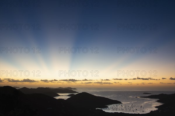USA, United States Virgin Islands, St. John, Sunbeams over Caribbean Sea at sunset