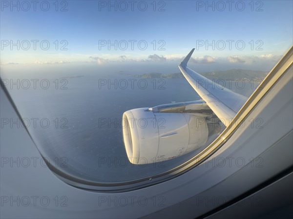 USA, United States Virgin Islands, St. Thomas, Airplane engine and Caribbean Sea seen through jet window