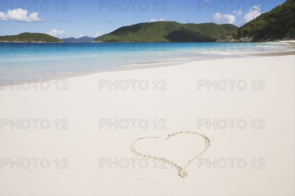 USA, United States Virgin Islands, St. John, Cinnamon Bay, Pair of yellow flip flops on sandy beach