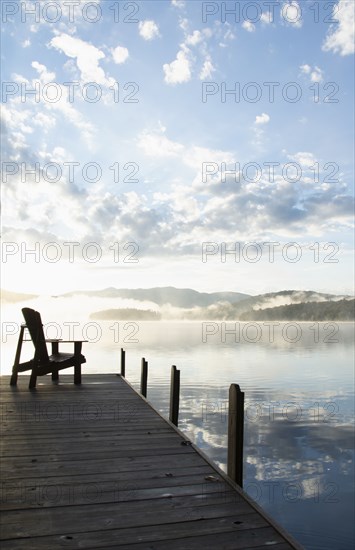 Boat dock at sunrise, Lake Placid, New York, USA