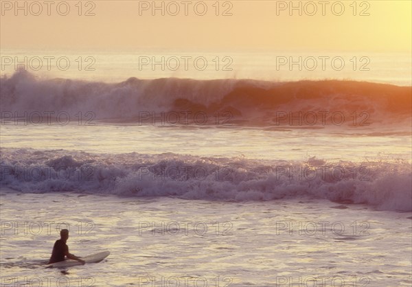USA, NJ, Lone surfer on Spring Lake at sunrise