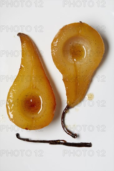 Overhead view of slices of baked pears with vanilla bean