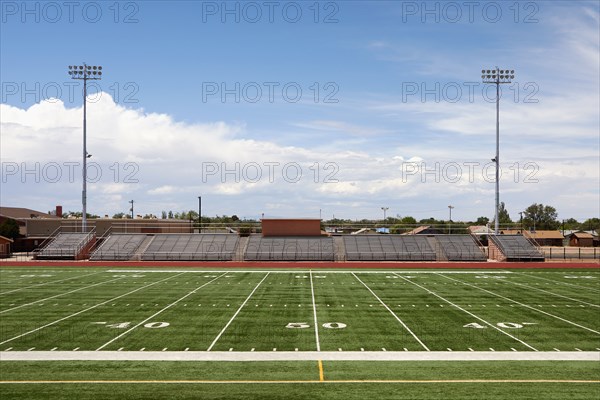Empty football field and bleachers