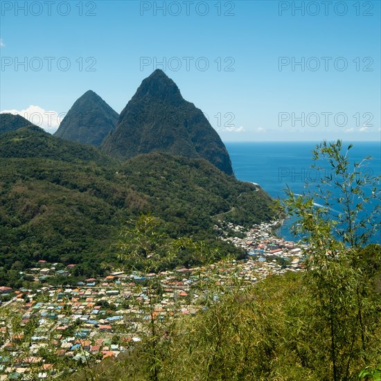 Town in hilly landscape with sea in background