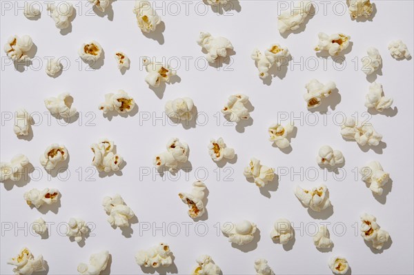 Overhead view of popcorn on white background