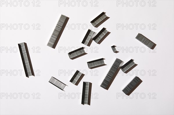 Overhead view of staples on white background