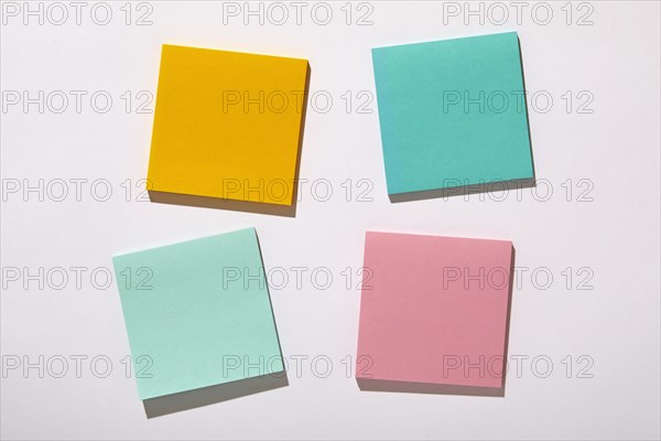 Colorful blank adhesive notes on white background